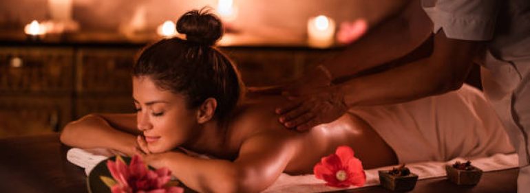 Beautiful woman enjoying on a massage treatment at the spa.